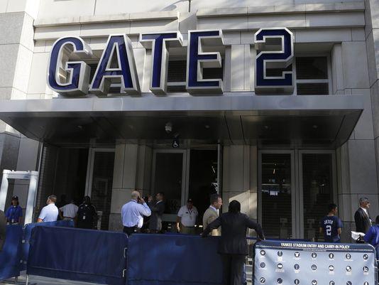 Fans go through metal detectors at Yankee Stadium